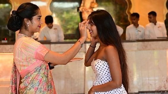 A receptionist welcoming a woman to our palace in a traditional Rajasthani way by placing sindoor on her forehead - Kaldan Samudra Palace